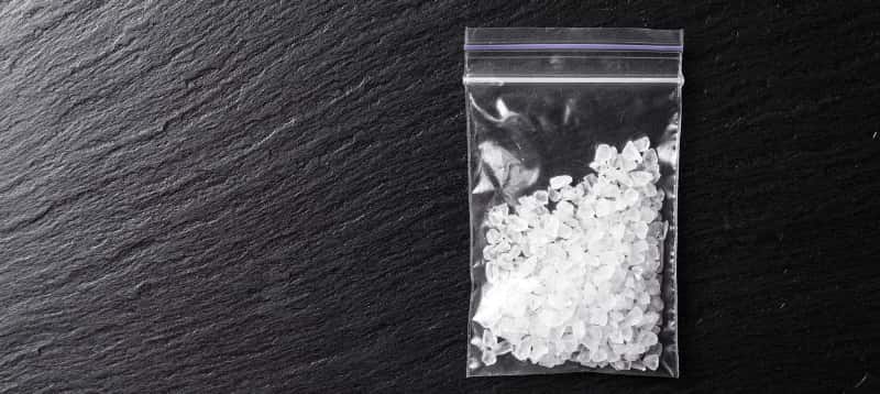A baggie filled with crystalline substance, representing amphetamines commonly associated with substance abuse and addiction.