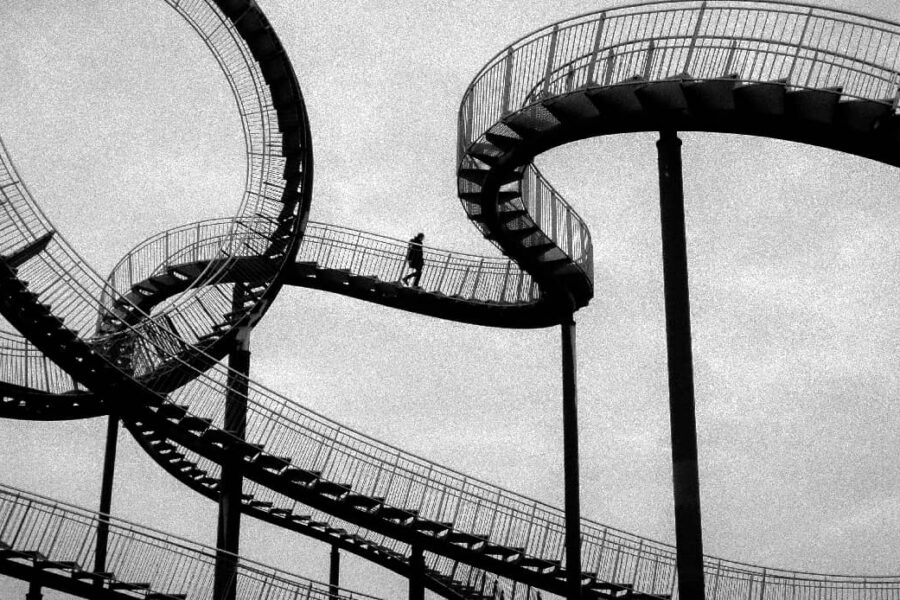 2. Close-up of a rollercoaster track with sharp twists and turns, symbolizing the emotional and situational ups and downs that are key reasons relapses happen in the journey of recovery.