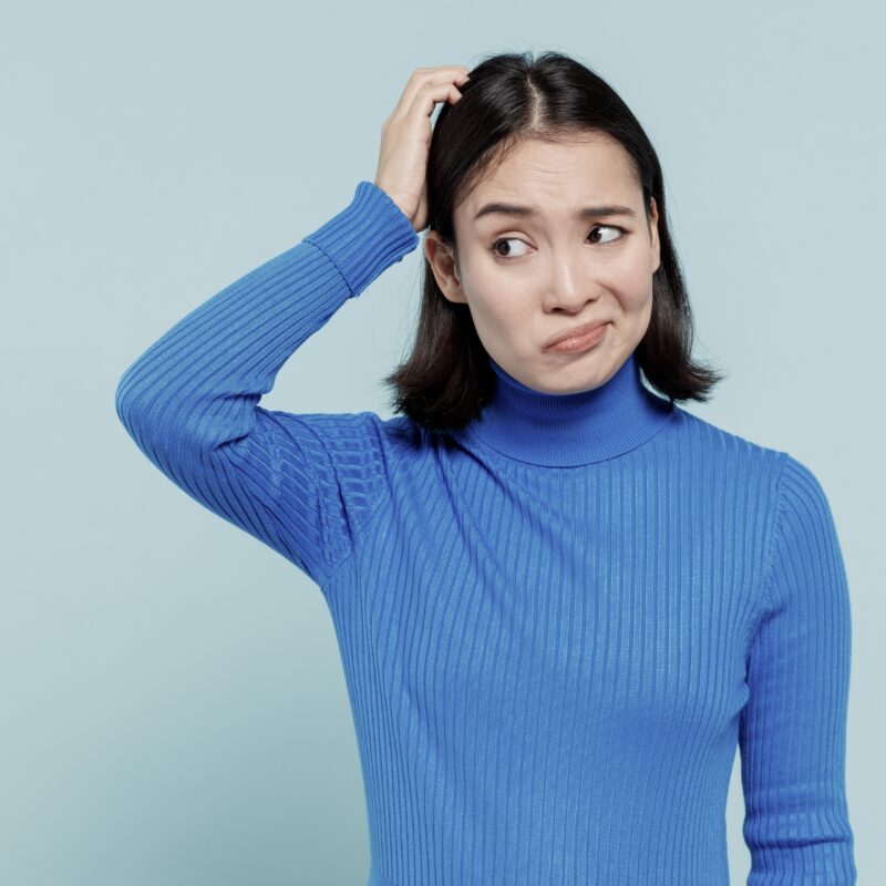 Woman in blue sweater thinking how to tell her partner to go to drug detox