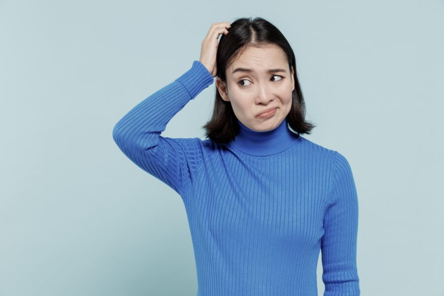 Woman in blue sweater thinking how to tell her partner to go to drug detox